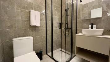 Luxury Room, Balcony, City View | Bathroom | Shower, hair dryer, slippers, towels