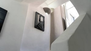 A staircase with a wall-mounted mirror reflecting a staircase.