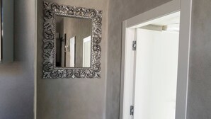 A mirror with an ornate frame mounted on a wall.