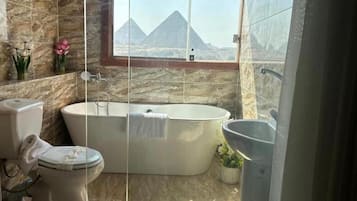 Deluxe Triple Room | Bathroom | Separate tub and shower, rainfall showerhead, hair dryer, slippers