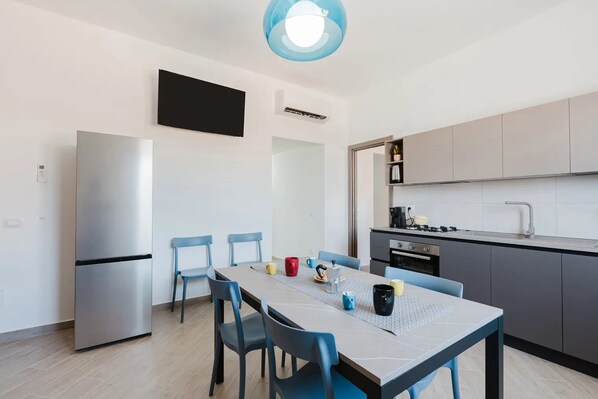 A modern kitchen with a dining area.