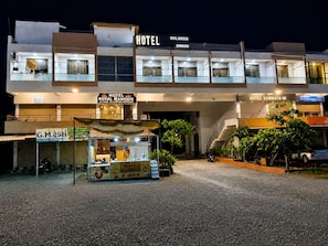 A hotel with a two-story structure, a covered entrance, and a visible staircase leading to the upper floor. - HOTEL ROYAL MANSION SOMNATH (Veraval)