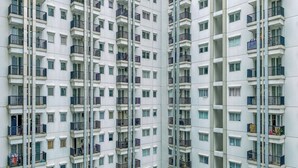 A high-rise residential building with multiple balconies, each with a small window and a railing. - Spacious and Homey 2BR at Signature Park Grande Apartment (Jakarta)