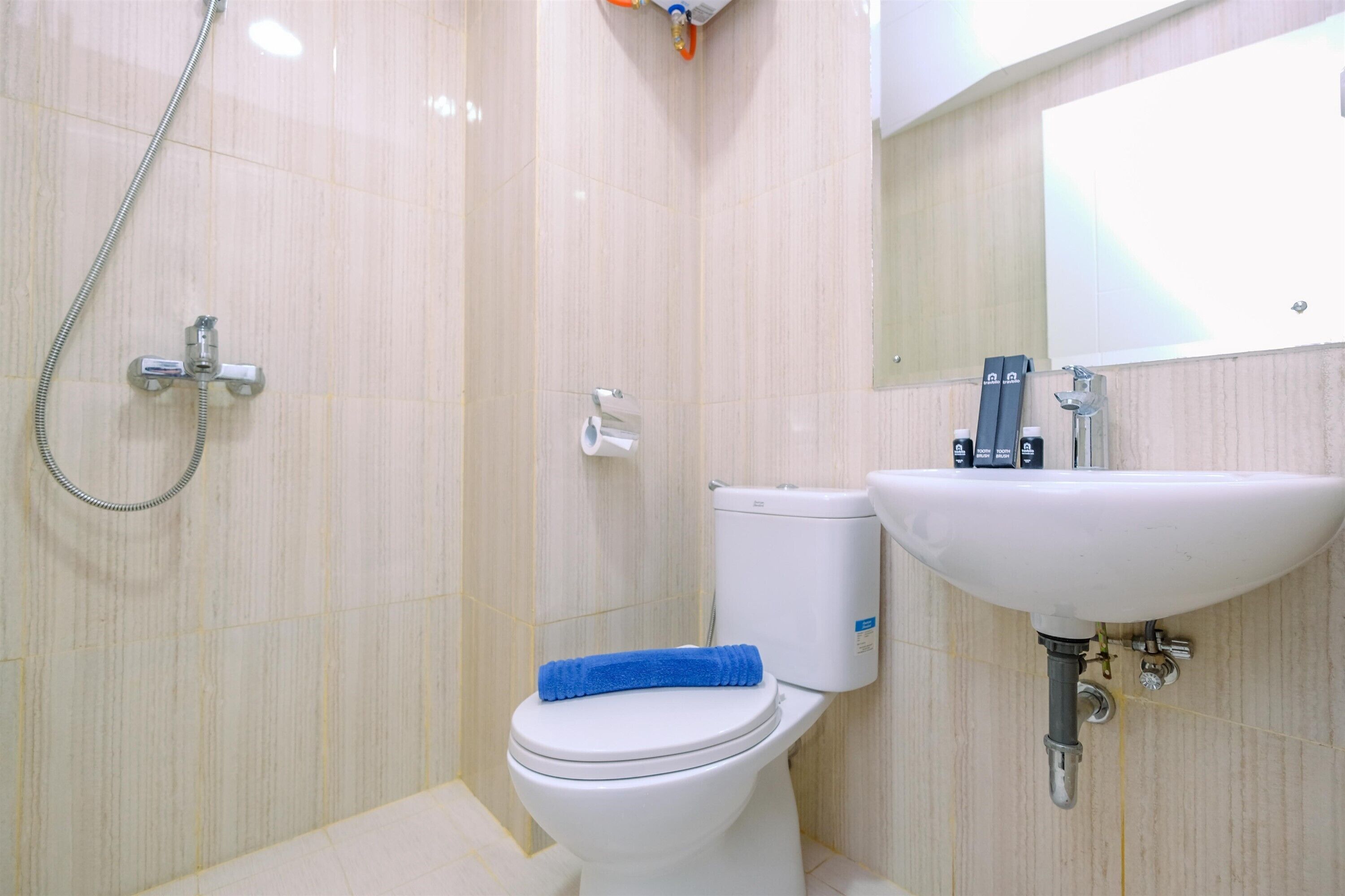 A bathroom with a toilet, a sink, and a shower.