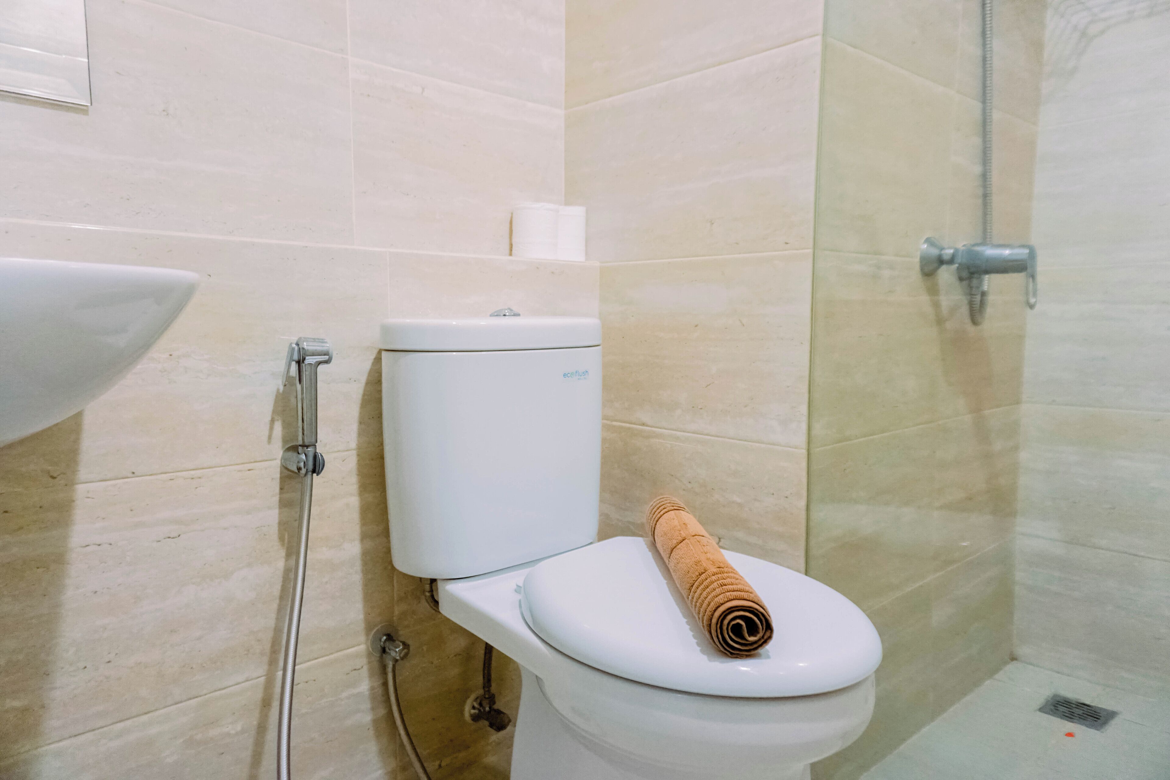 A bathroom with a toilet, a sink, and a shower.
