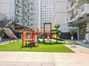 Children can play on the swing set, climbing structure, and slide in this well-maintained outdoor playground.