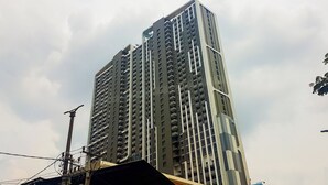 A high-rise building with multiple balconies and a modern architectural design.