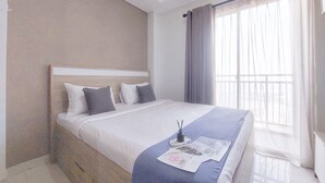 Une chambre d’hôtel moderne avec un grand lit, une table de chevet et une fenêtre avec des rideaux.