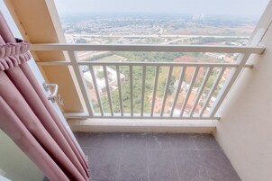 A balcony with a view of a highway and buildings.