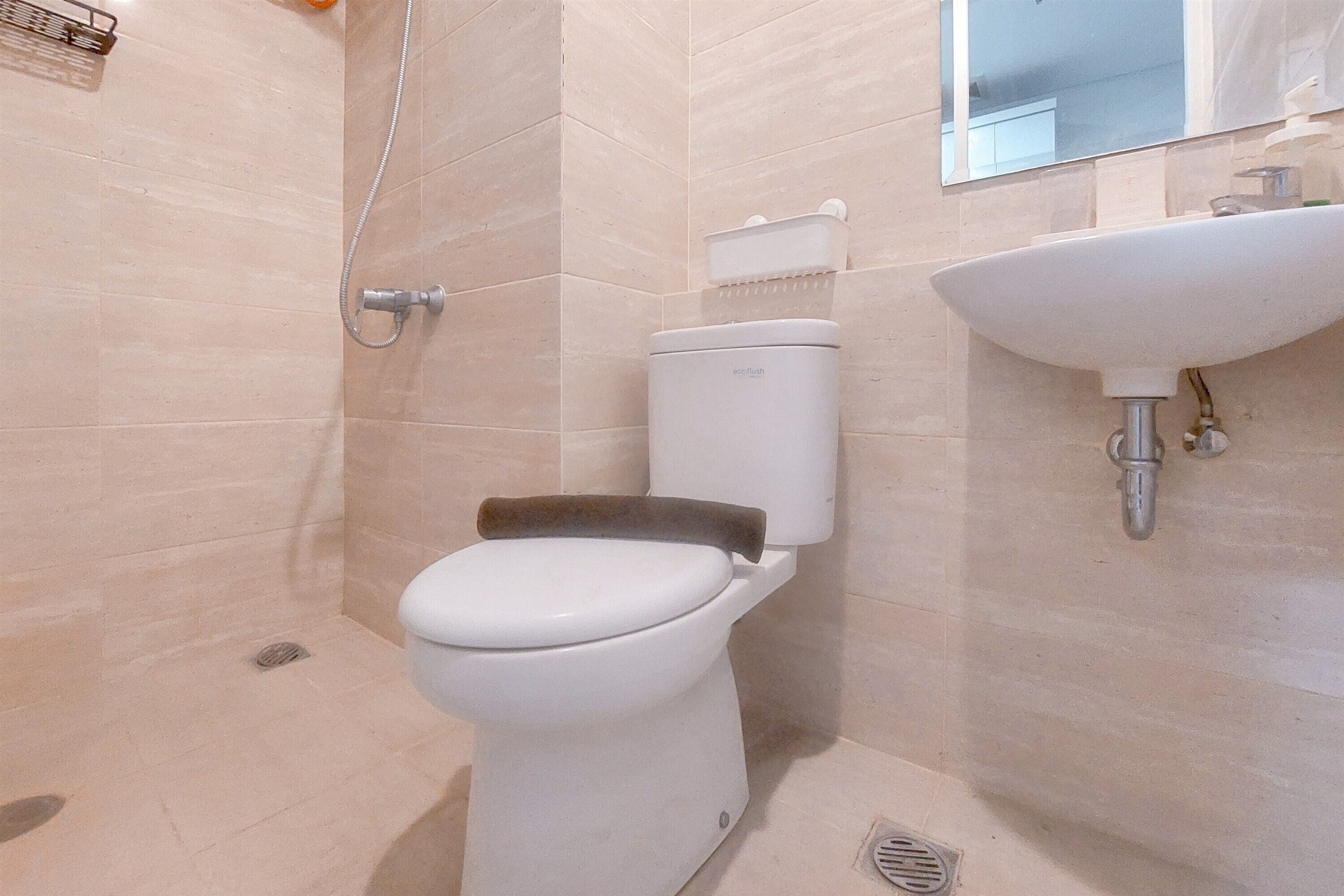 Une salle de bain moderne équipée de toilettes, d’une douche et d’un lavabo.