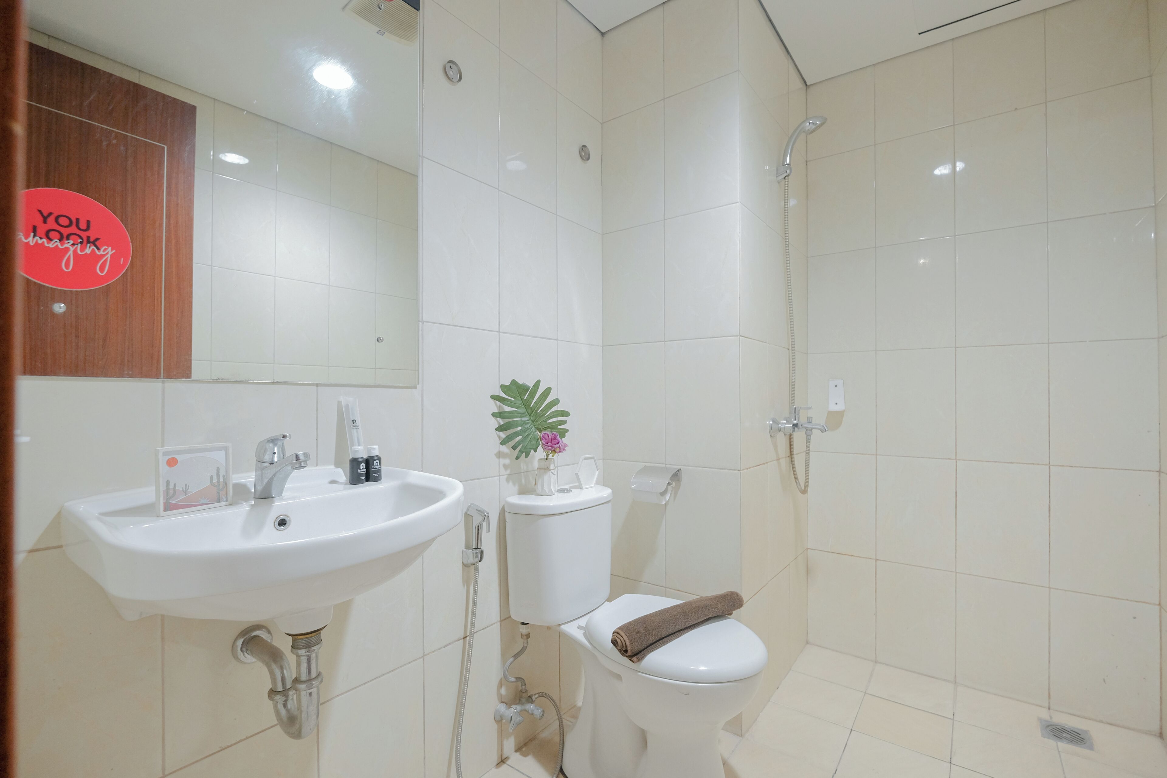 A bathroom with a sink, toilet, and shower.