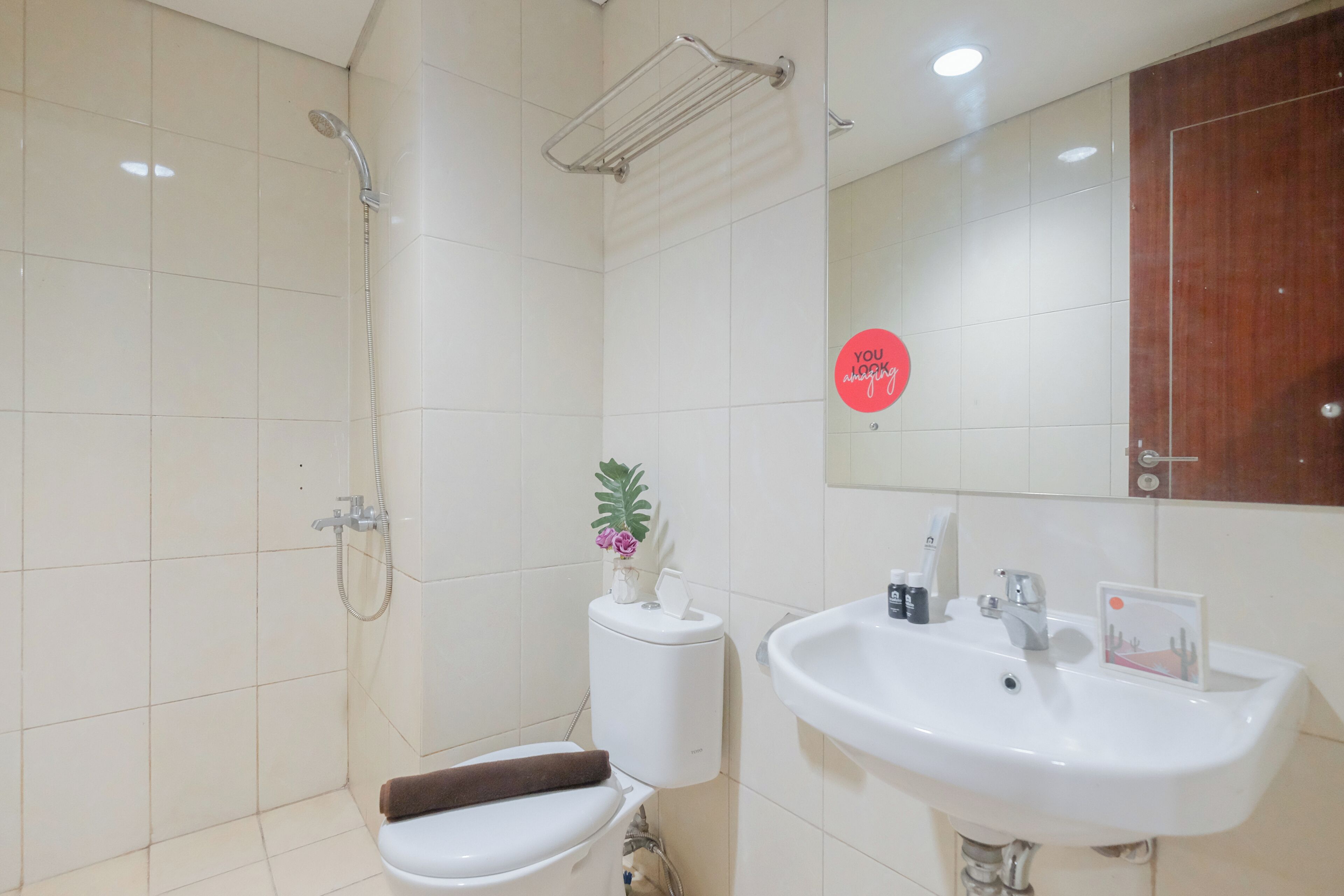 A bathroom with a toilet, sink, and shower.