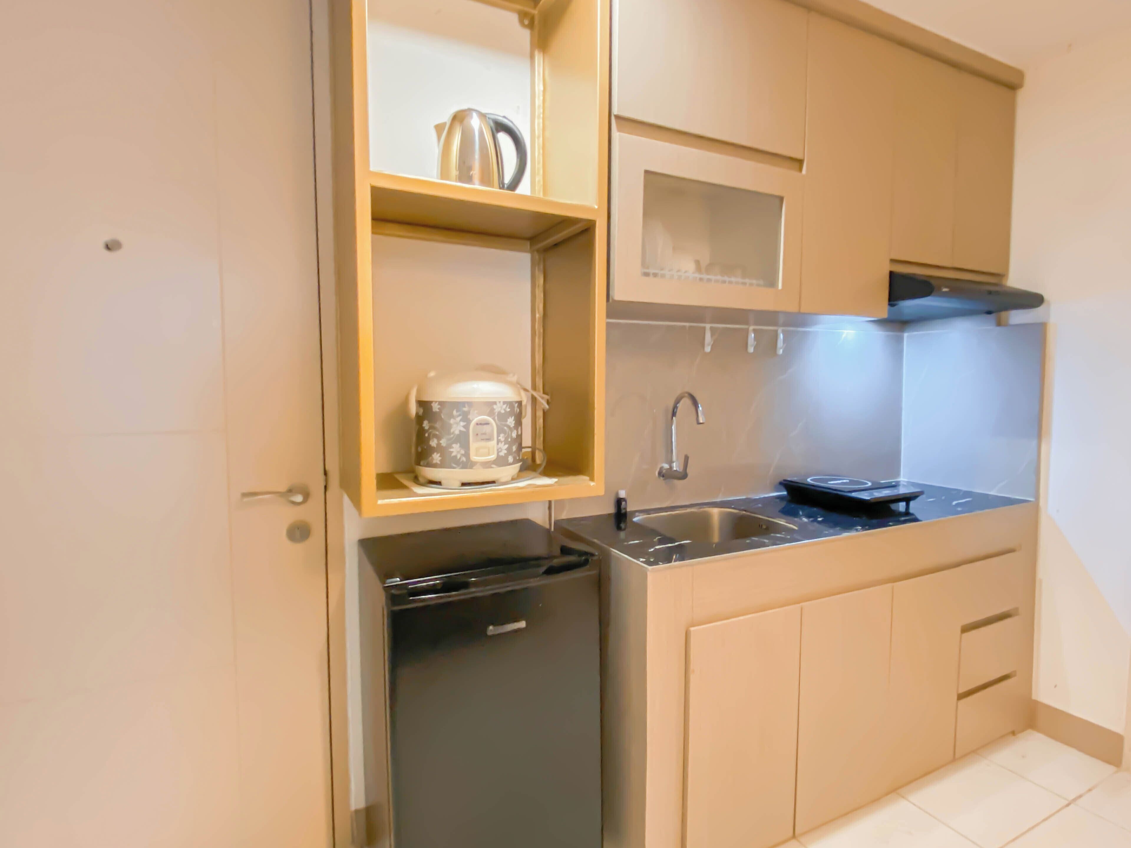Een kleine keuken met een inbouw vaatwasser, een spoelbak en een kookplaat.