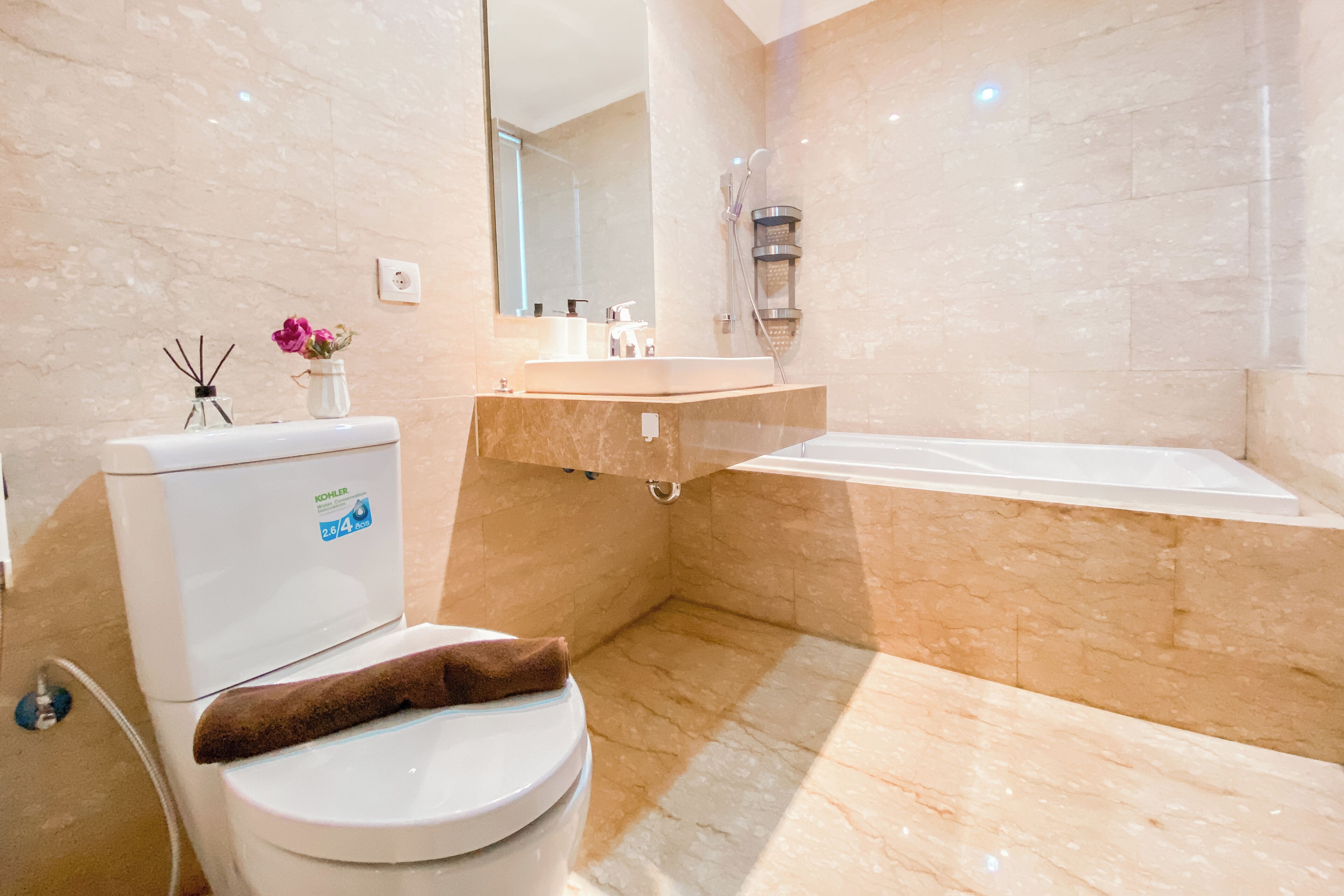 A modern bathroom with a toilet, sink, and bathtub.