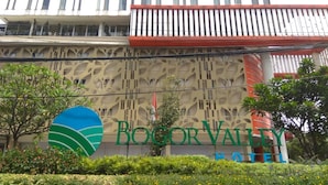 The exterior of the Bocor Valley Hotel with a distinctive facade and a prominent sign. - Nice and Cozy Studio at Bogor Valley Apartment (Bogor)