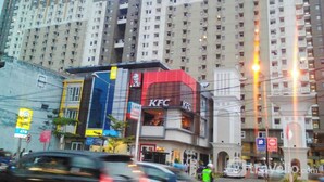 A multi-story building with a KFC restaurant on the ground floor.