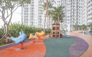 Children's play area - outdoor - Cozy and Spacious 1BR at Anderson Supermall Mansion Apartment (Surabaya)