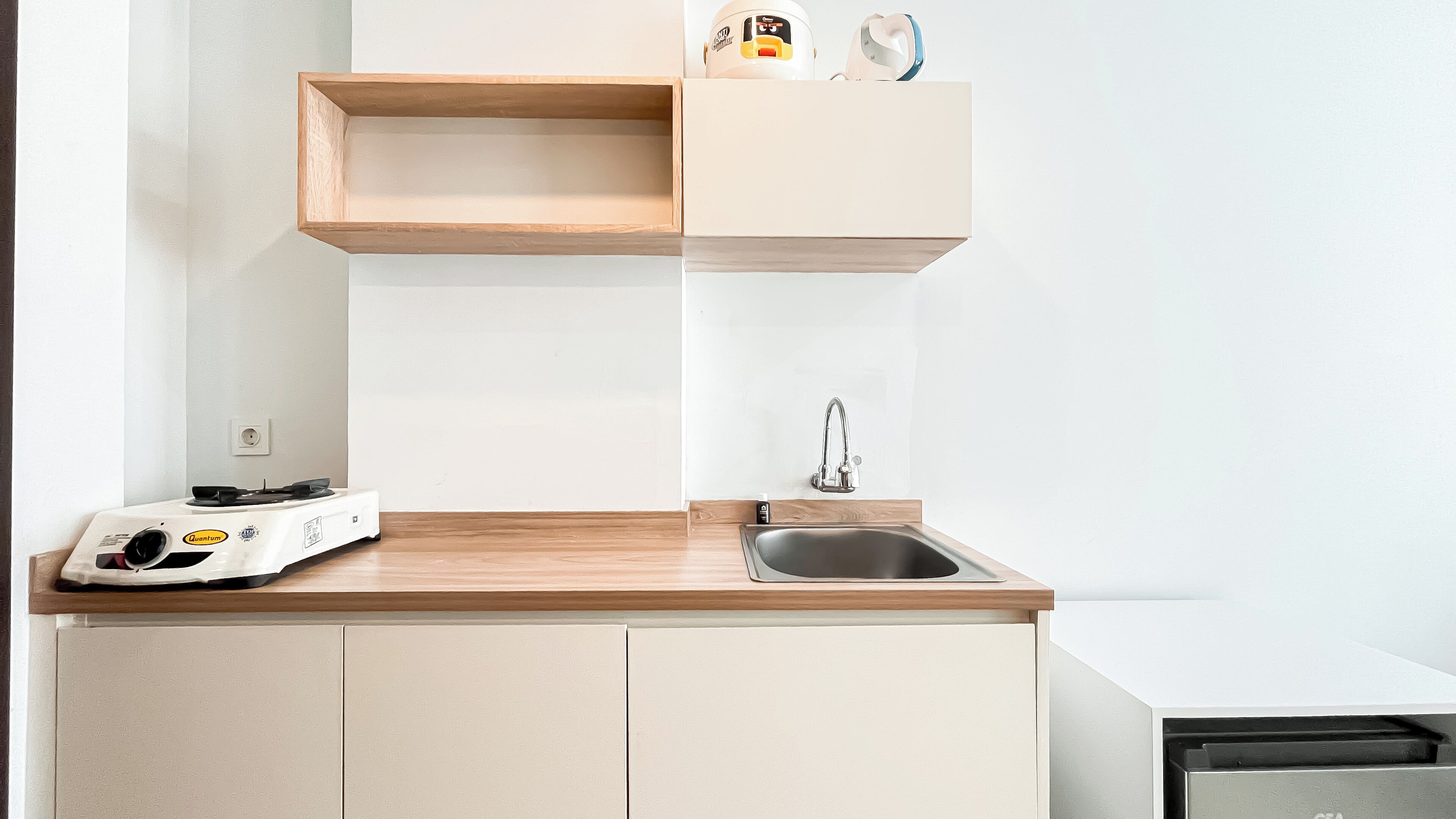 A kitchen with a wooden countertop, a sink, and a dishwasher.