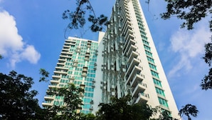 A high-rise building with multiple balconies and a modern architectural design. - Spacious 1BR at Tree Park City BSD Apartment (South Tangerang)