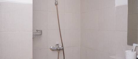 A bathroom with a shower, a sink, and a toilet.