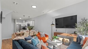 A modern living room with a sofa, coffee table, and TV.