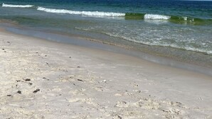 A beach with clear skies and gentle waves. - Plantation 2215 (Gulf Shores)