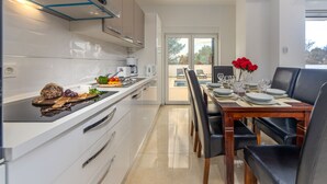 A modern kitchen with a dining area.