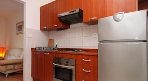 Enjoy cooking in this well-equipped kitchen with an oven and refrigerator.