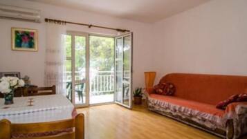 Apartment (One Bedroom Apartment with Balcony an) | Living room | 32-inch flat-screen TV with cable channels