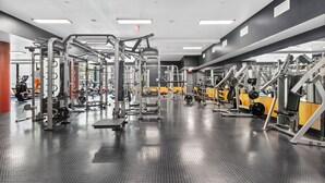 A gym with various exercise equipment, including weight machines and free weights.