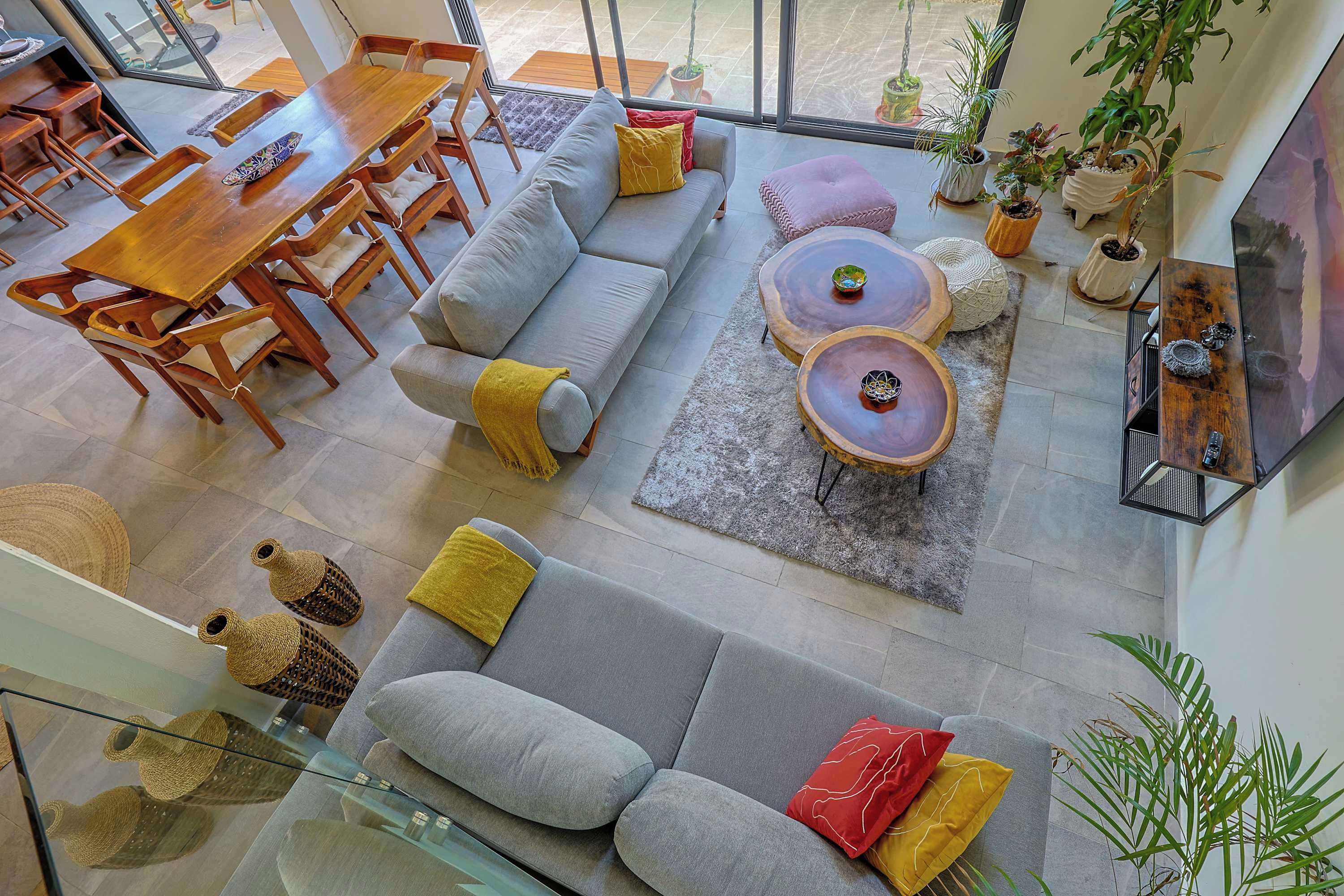 A modern living space with a dining area, seating arrangements, and a large window providing a view.