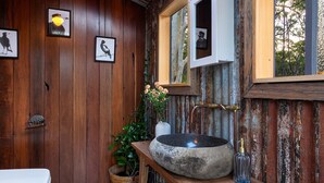 A rustic bathroom with wooden walls, a stone sink, and framed bird artwork. - The Hollows - Kangaroo Valley (Kangaroo Valley)