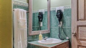 A bathroom with a sink, mirror, towel rack, and hair dryer. - king Standart pool view (Tola)