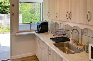 Fridge, stovetop, dishwasher, coffee/tea maker