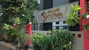 A sign for Kaira Park Hotels & Luxury Resorts with potted plants in front. - KAIRA PARK (Chennai)