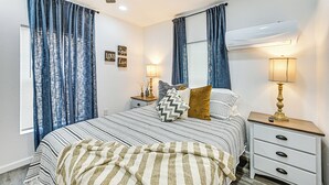 A bedroom with a bed, two bedside tables, a ceiling fan, and a window with curtains. - 1 Mi to Dtwn: Family Home w/ Porch in Brownwood (Brownwood)