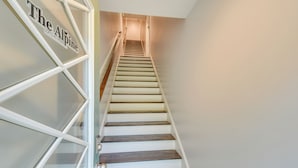 A staircase with a sign reading "The Alpine" leading to a landing. - Steps to River + Shops: Downtown Helen Retreat! (Helen)