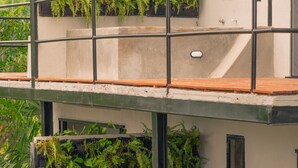 A multi-level building with balconies featuring vertical gardens. - Casa Xué: Soul of Tayrona (La Poza)