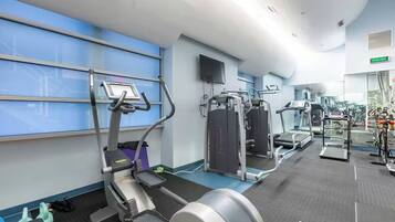 A gym with treadmills, elliptical machines, and weight equipment.