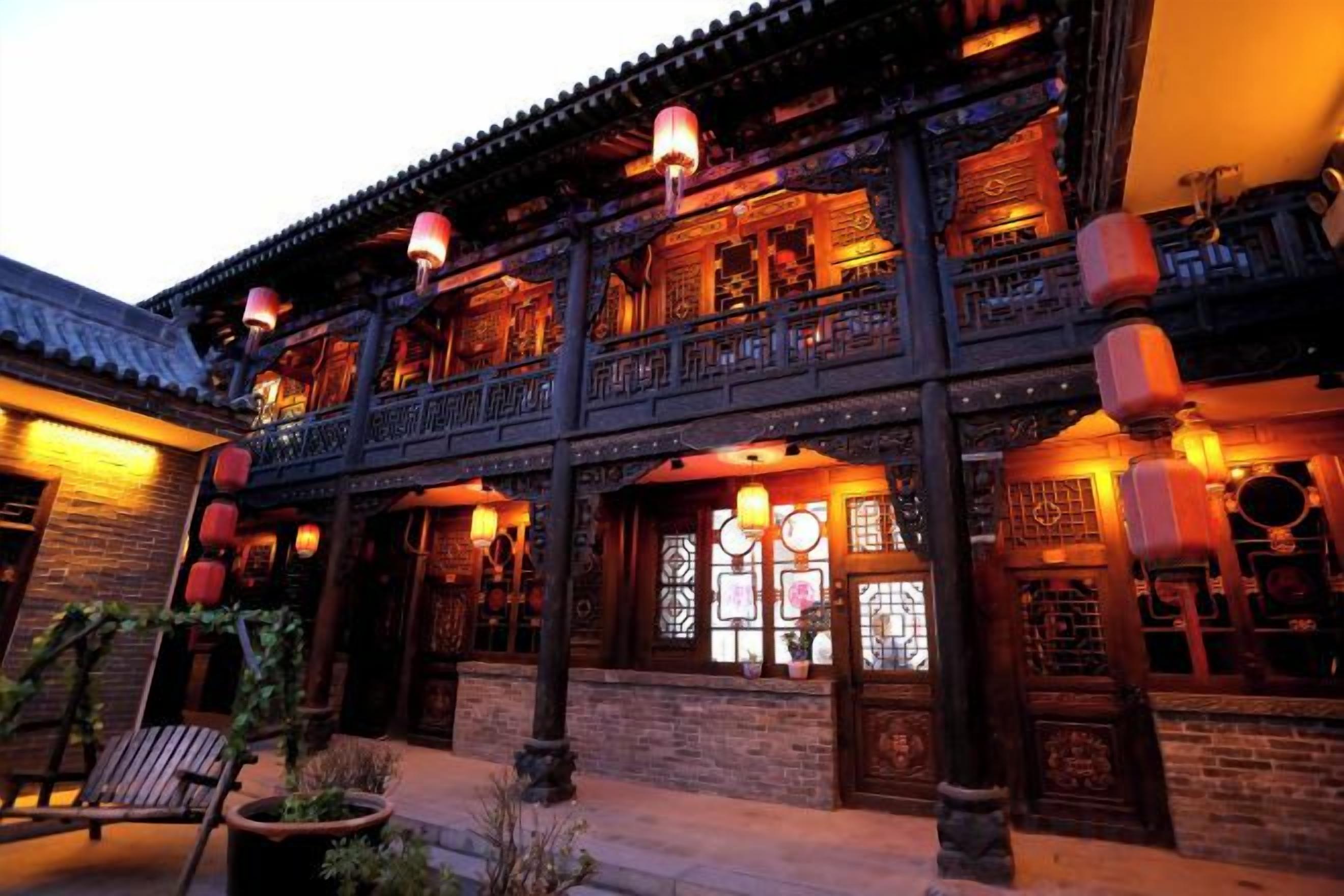 A traditional building with multiple balconies, wooden railings, and lanterns.