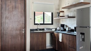 A modern kitchen with wooden cabinets, a stainless steel refrigerator, and a window with blinds. - Loft in La Veleta w/ Pool,Balcony and rooftop! Near beach cenotes downtown (Q.R.)