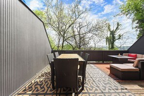 An outdoor patio with a dining table and chairs, a fire pit, and a sofa. - REGAL BRICKS - Giant Outdoor Chess/Fire Pit/Game Room/Private Deck/Fire Pit (Pittsburgh)