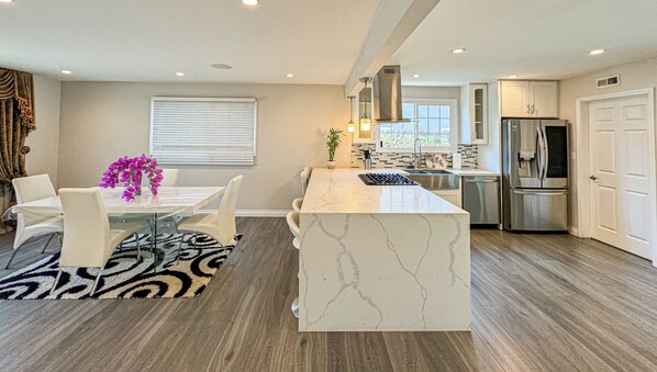 Enjoy cooking in this well-equipped kitchen with a large island and dining area.