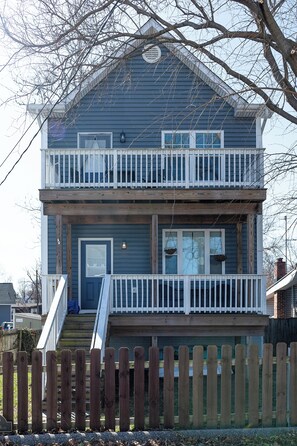 Traditional two-story residence with a charming balcony and central entrance.