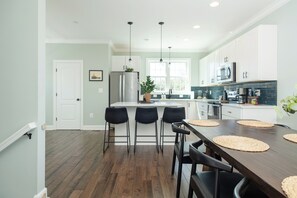 Enjoy meals at the central island or dining table in this well-equipped kitchen.