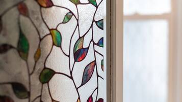 A close-up of a stained glass window with leaf patterns.