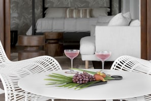 Enjoy a romantic dinner for two in this stylish outdoor dining area, complete with a beautifully set table and elegant decor.