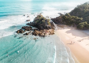 Enjoy the serene coastal landscape with turquoise waters and lush greenery.