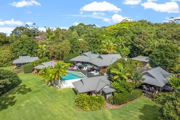 Escape to a serene tropical haven with pools and lush gardens, nestled in a dense forest.