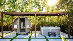 A hot tub under a pergola with string lights, surrounded by a stone patio and greenery. - ` Velvet Bloom ` unique location 3mil to Downtown (Naples)